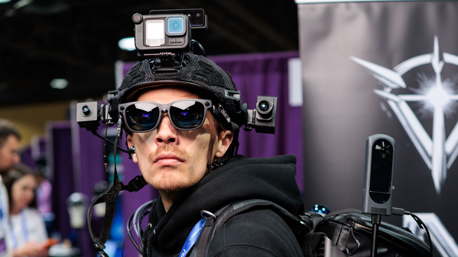 Attendee wearing smart glasses and a spatial computing camera rig