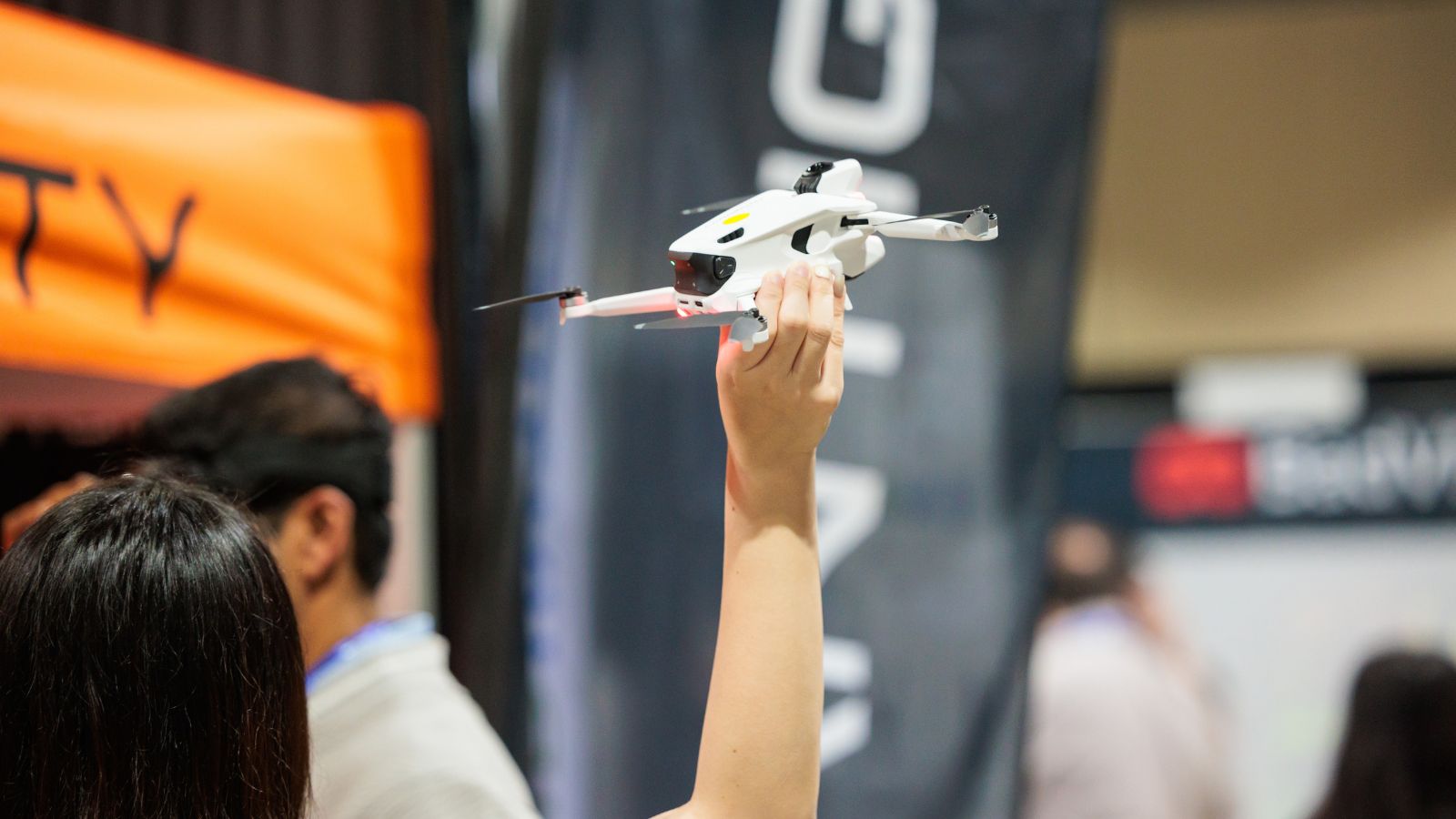 Attendee holding a miniature flying robot