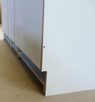 Three cabinets bolted together, each with a skirting notch of 150mm to ride above the skirting in the install location