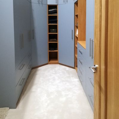Walk-in wardrobe with denim U540 frontages and Winchester Oak H1381 carcass
