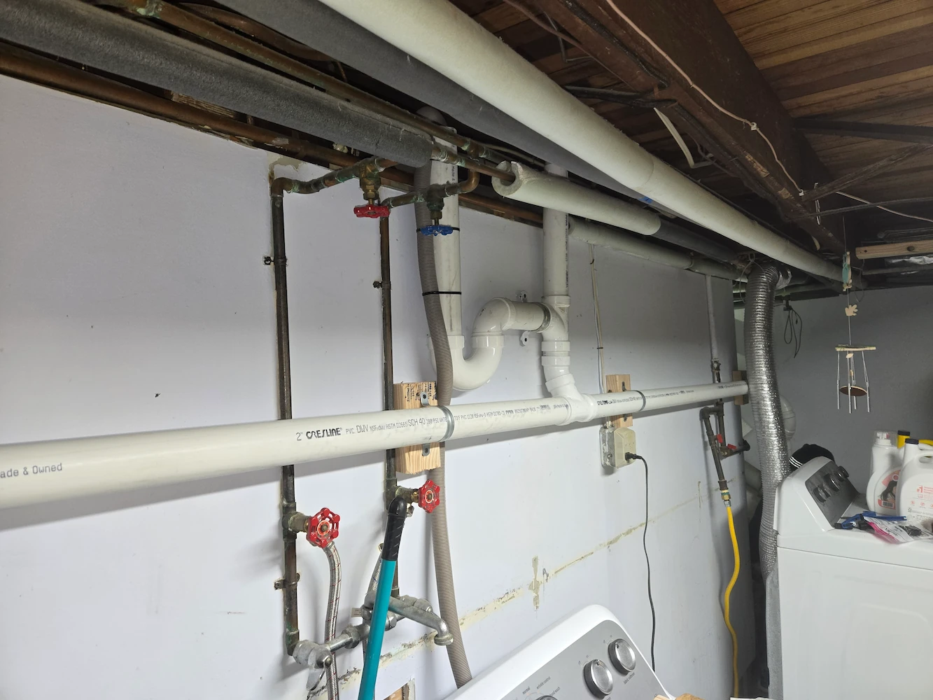 Mount Wolf laundry drain repipe showing new PVC standpipe tied into the existing stack