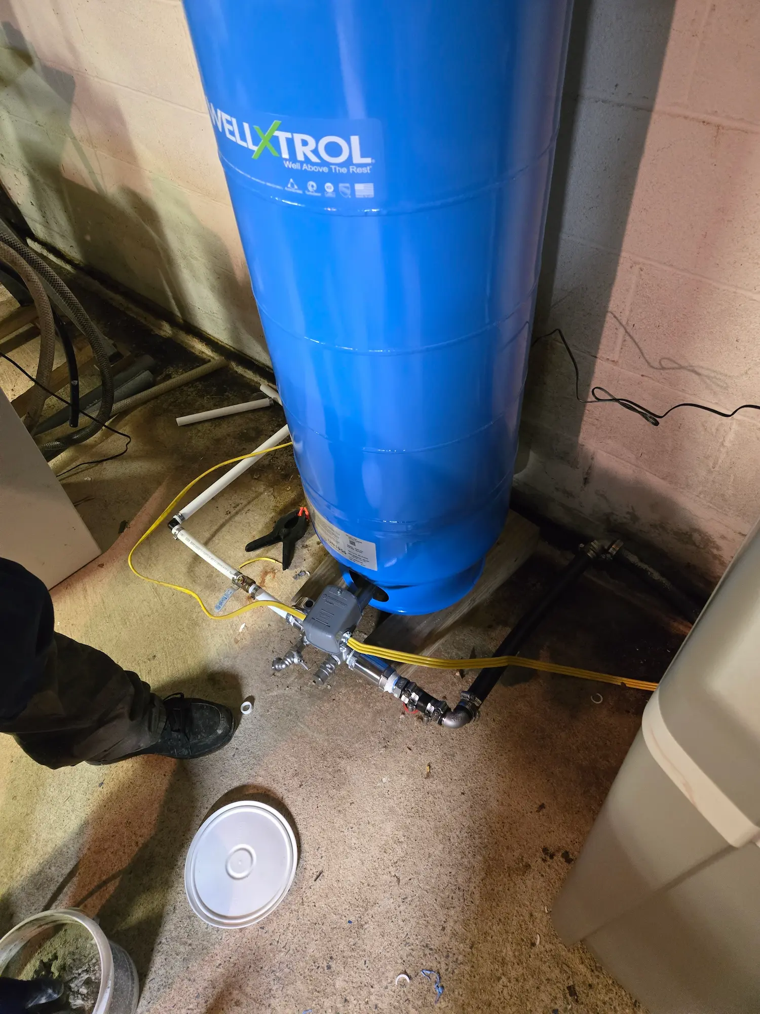 Close-up of a Camp Hill Well-X-Trol pressure tank tee with pressure switch, gauge, and drain