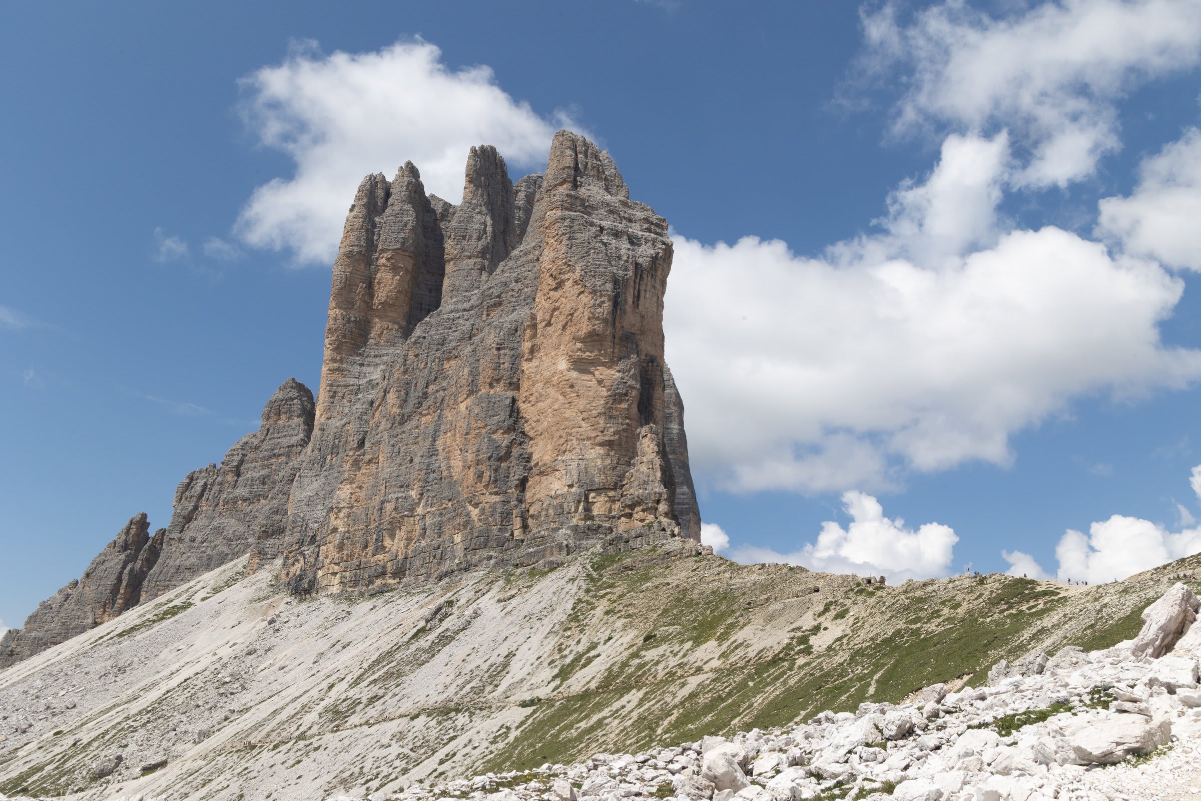 The iconic three peaks of Tre Cime emerging through gathering clouds