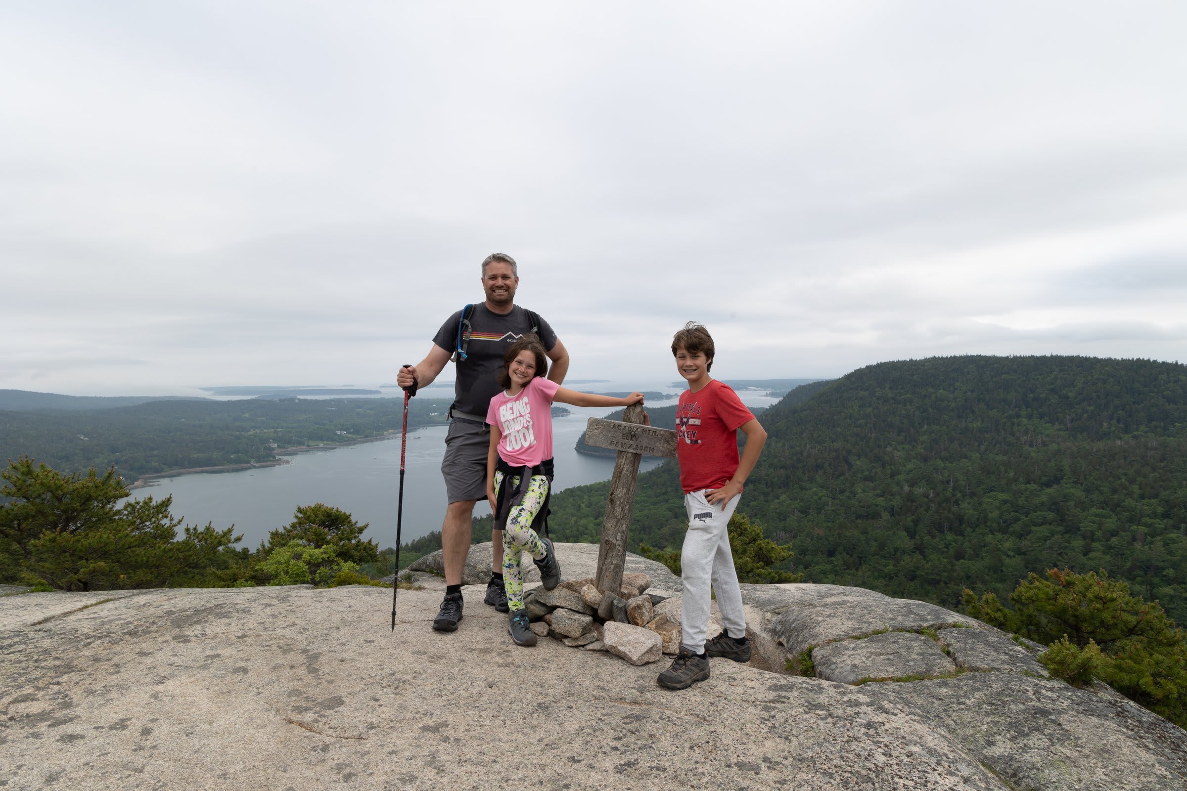 Family at the Cadillac Mountain summit taking in the panoramic views