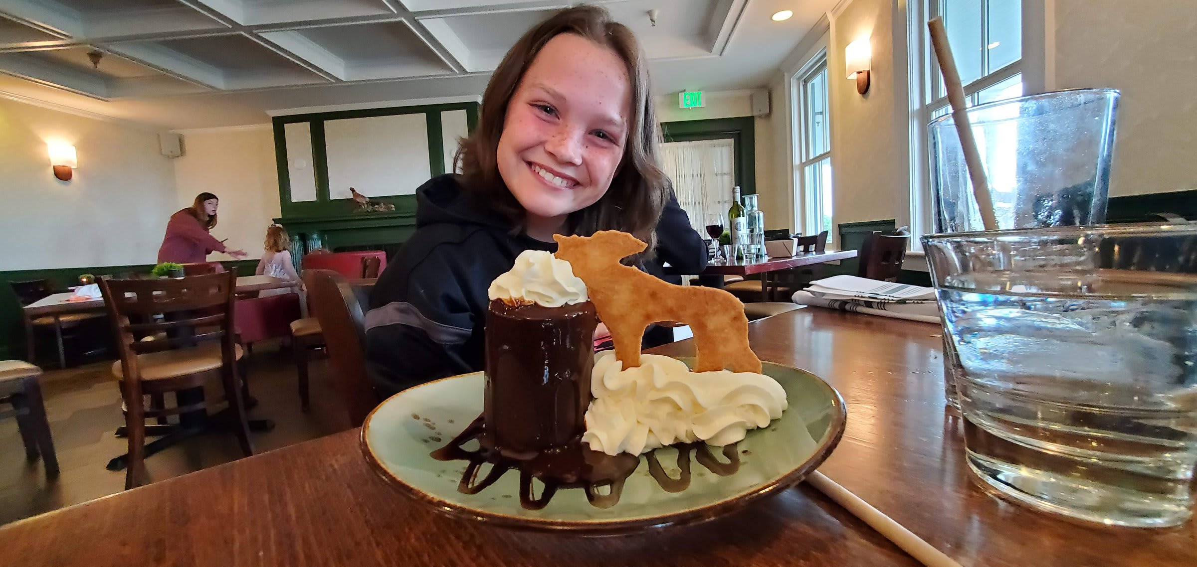 A chocolate dessert topped with a donkey-shaped cookie at dinner