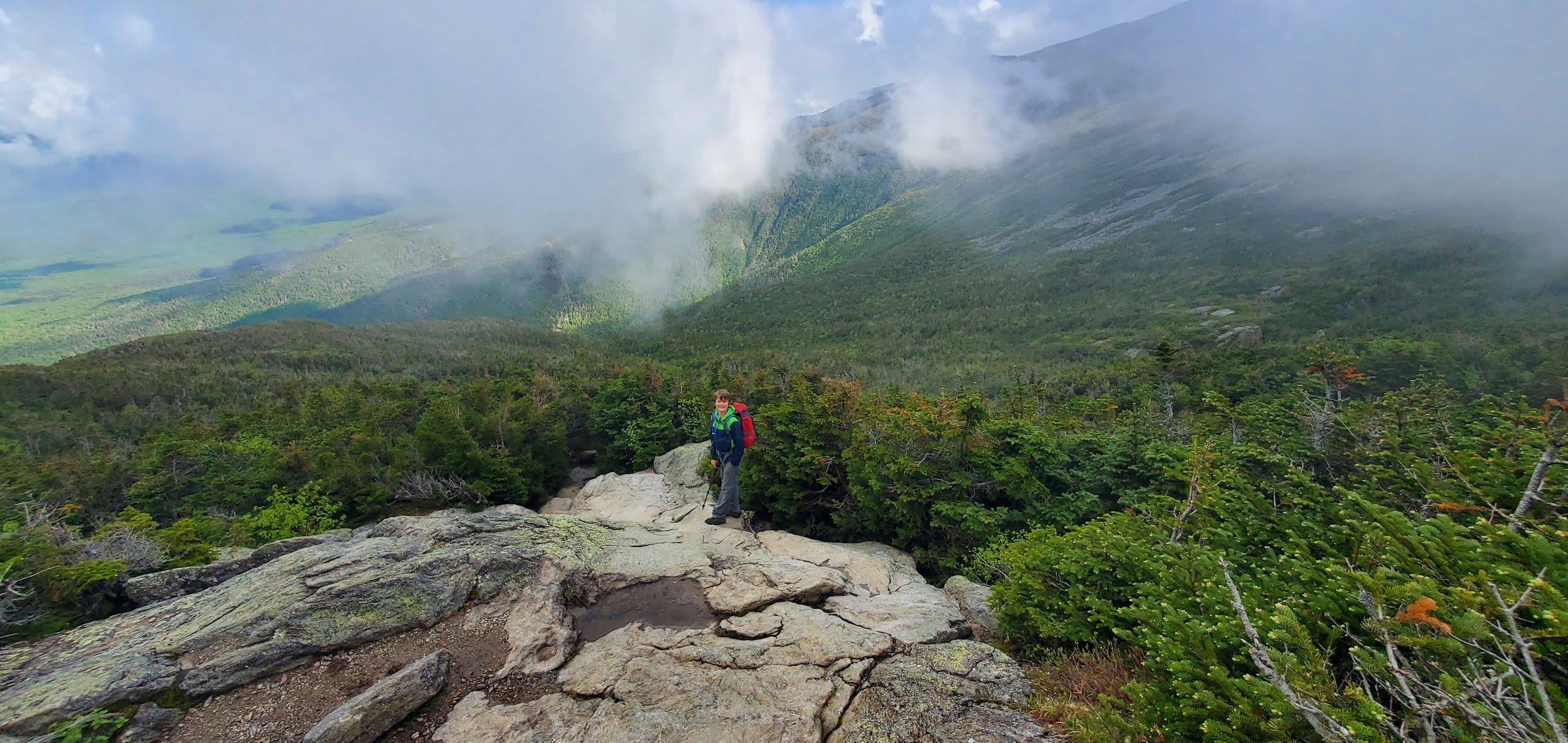 Clouds pouring over the ridge as we started down