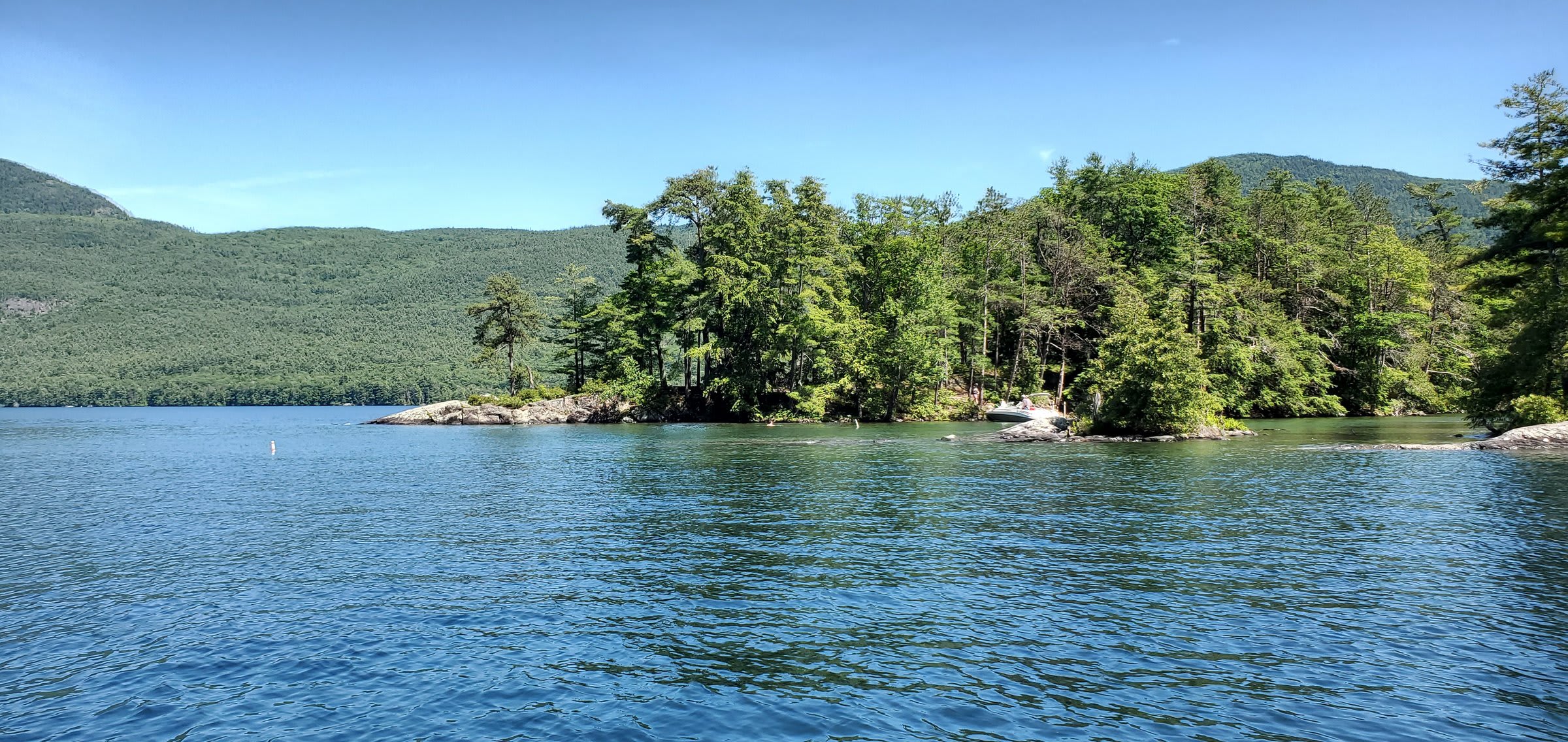 Kids jumping off rocks into the lake