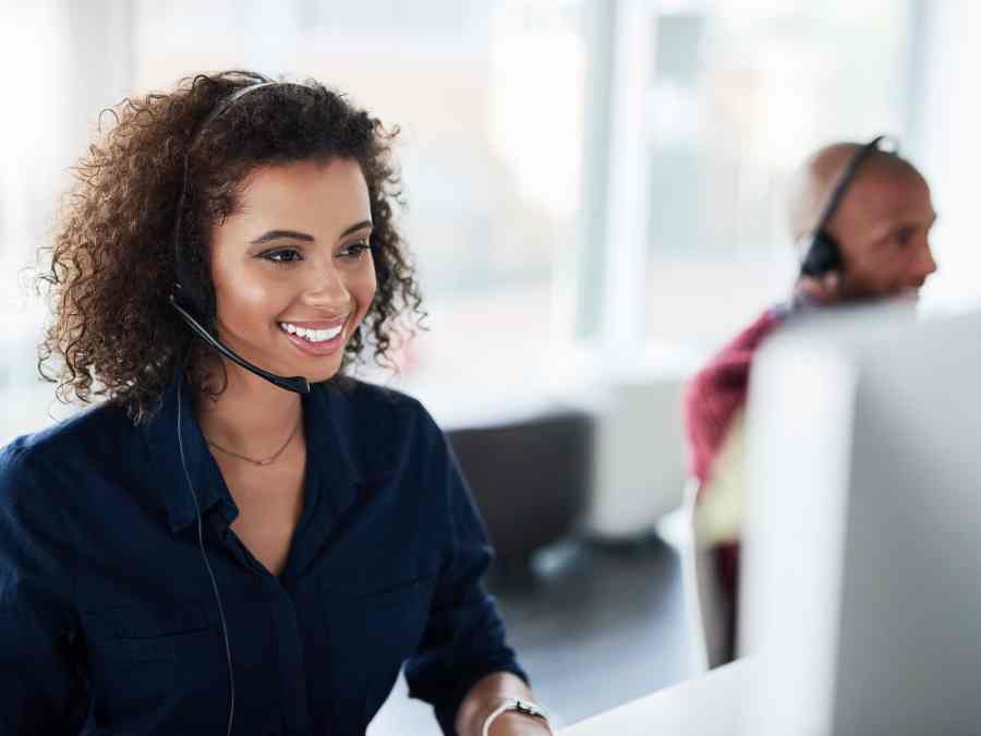 Smiling woman wearing a headset, working in an enterprise call center