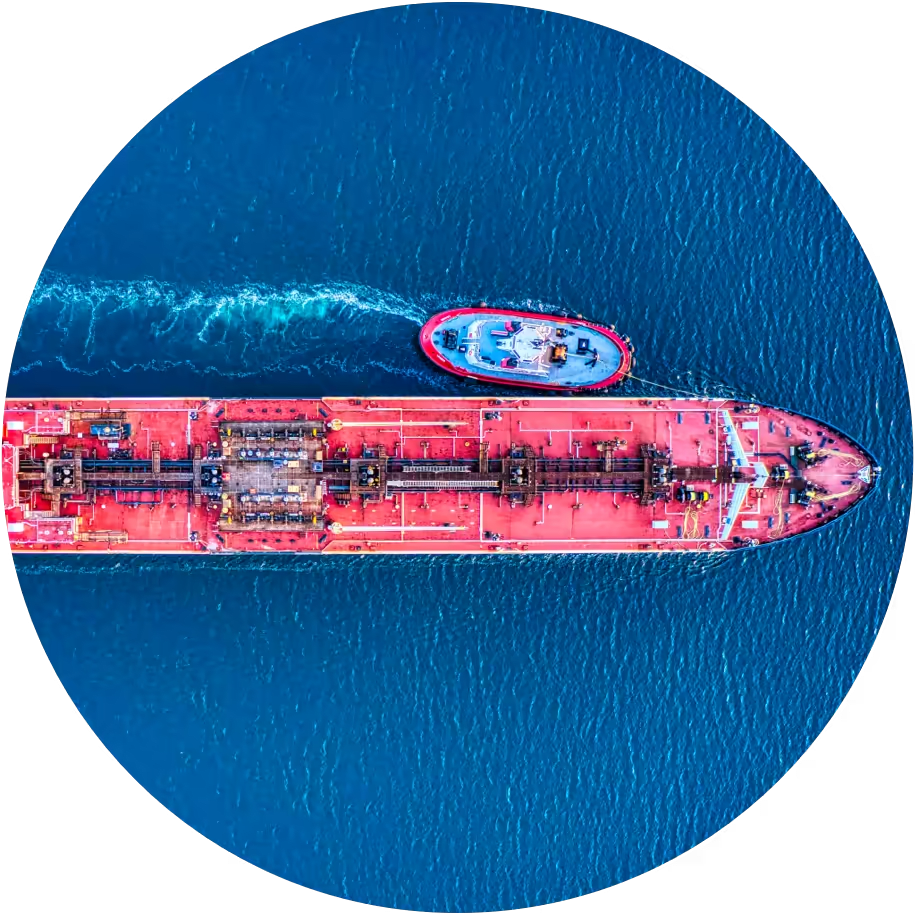 oil tanker in a bay with tug boat