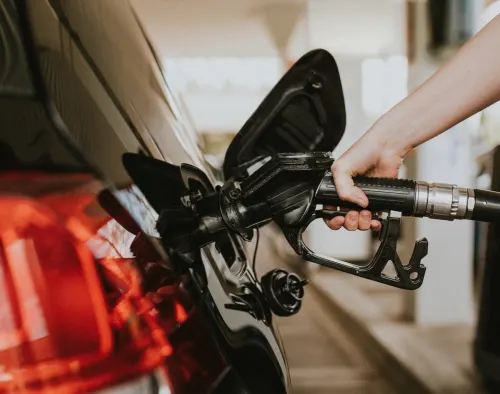 car being filled refueled at a service station