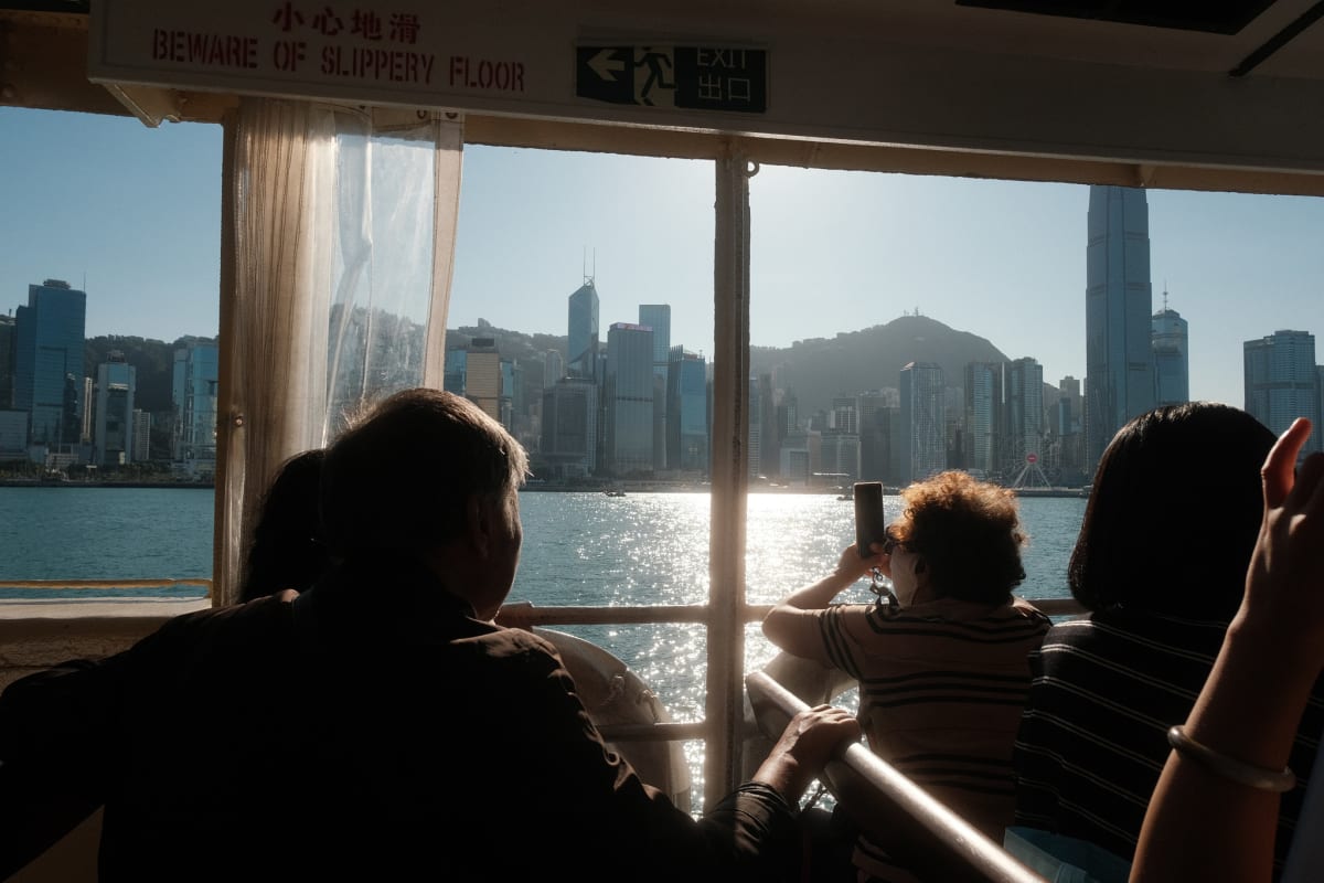 The Hong Kong skyline over people's heads on the ferry.