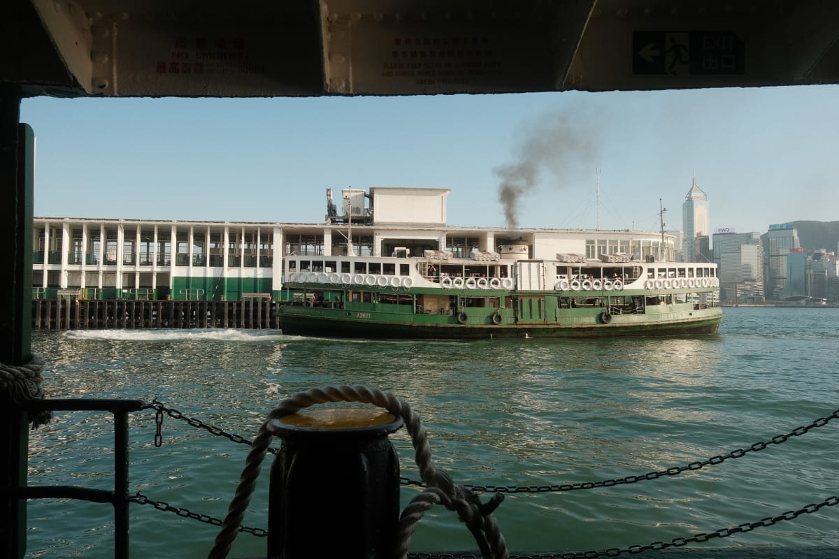 A billow of black smoke rises from the Star Ferry as it docks at the Tsim Sha Tsui terminal.