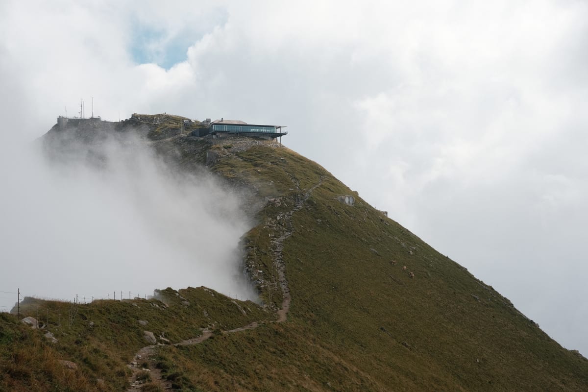A mountain surrouneded by clouds.