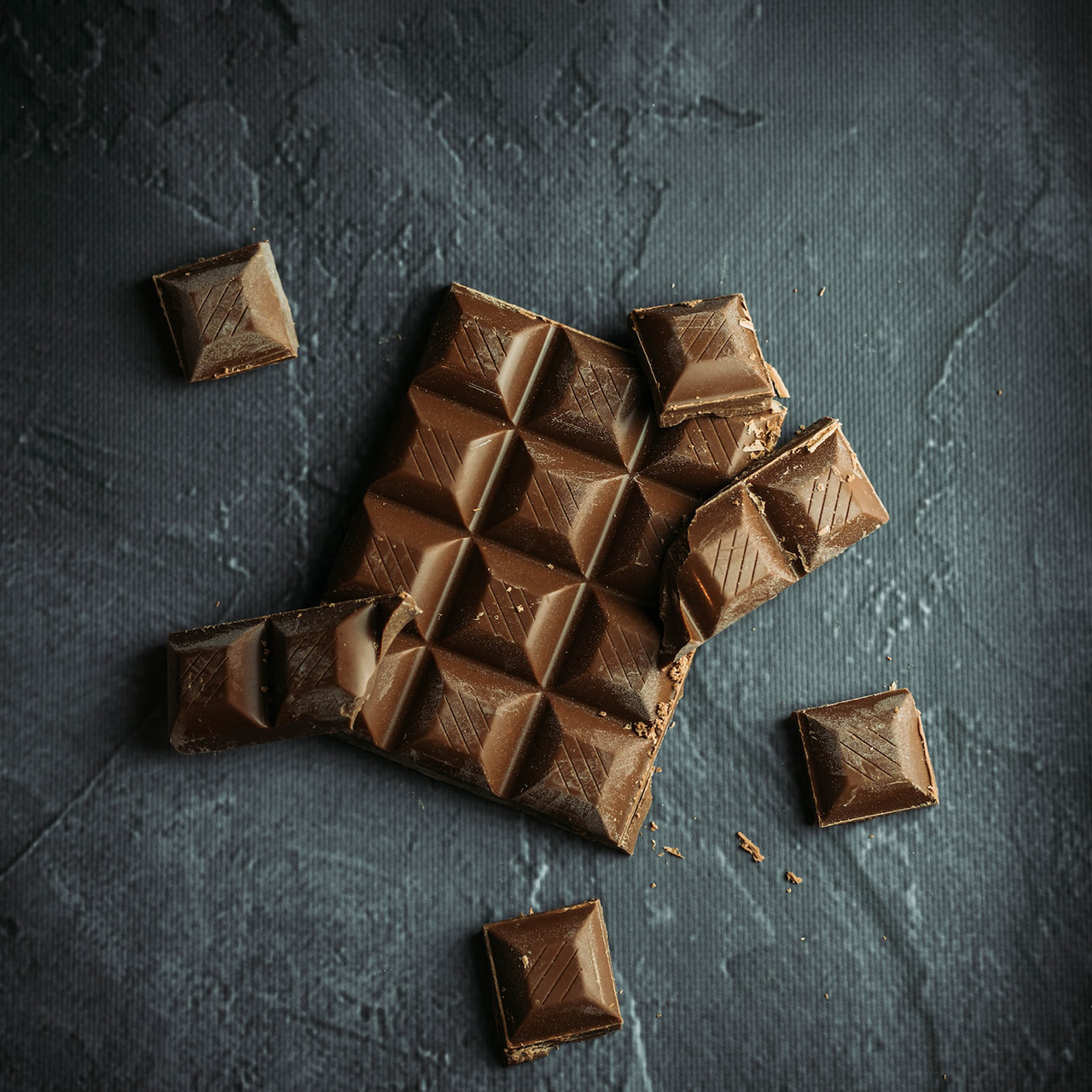 A bar of chocolate broken into smaller pieces.