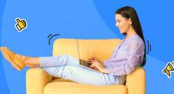 a lady sitting on a couch and writing on the computer