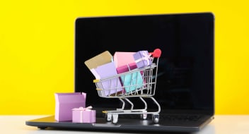a shopping cart with gifts on a laptop
