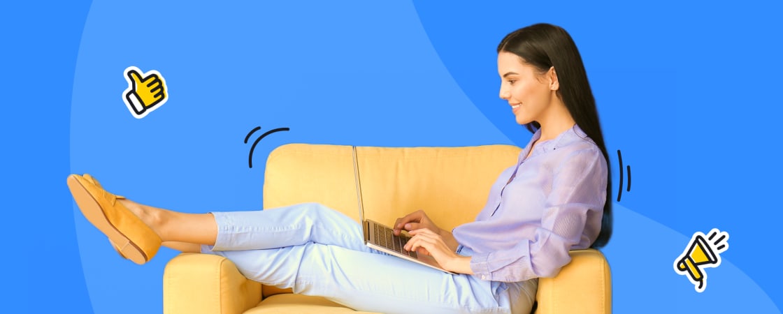 a lady sitting on a couch and writing on the computer