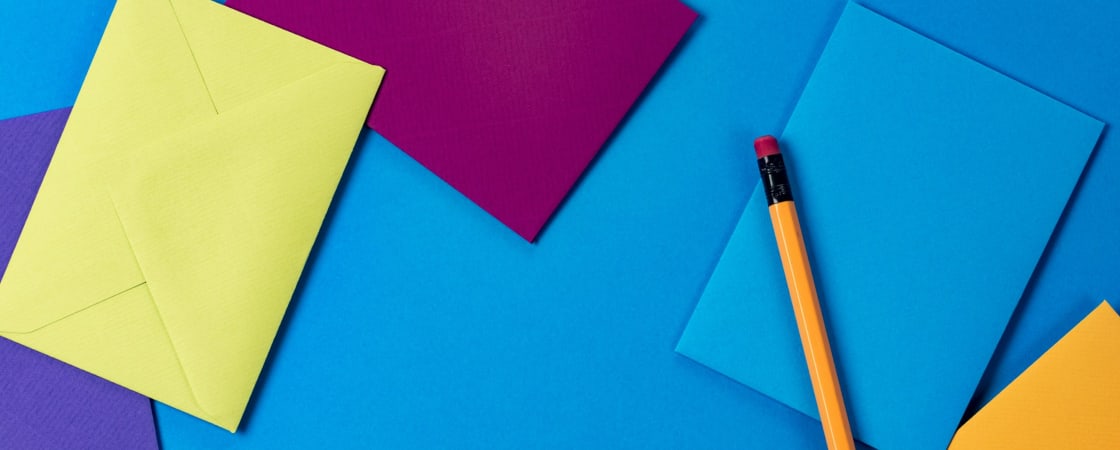 papers on blue table with pencil