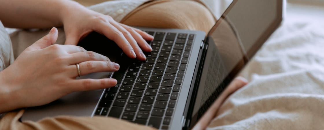 a person typing on a laptop's keyboard