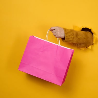 a hand keeping a pink bag