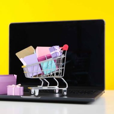 a shopping cart with gifts on a laptop