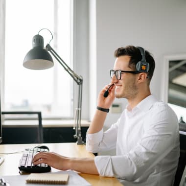 a customer support agent in front of a computer