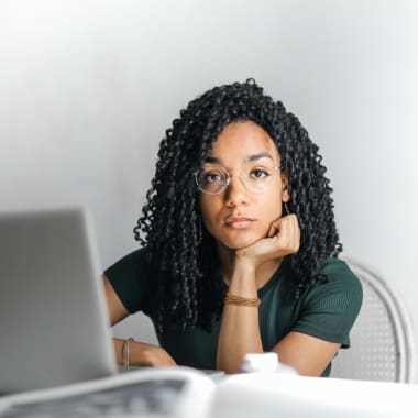 a woman sitting in front of computer