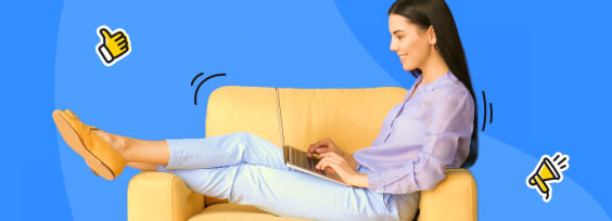 a lady sitting on a couch and writing on the computer