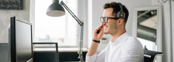 a customer support agent in front of a computer