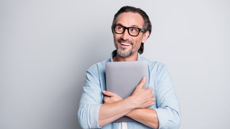 a smiling man with a computer