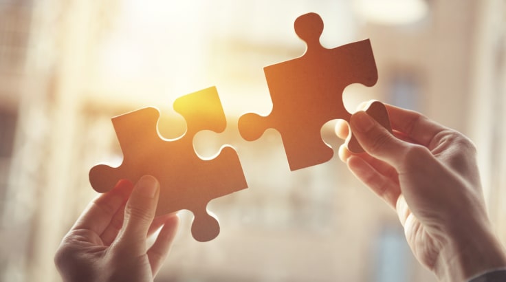 Businesswoman hand connecting jigsaw puzzle with sunlight effect, Business solutions, success and strategy concept.