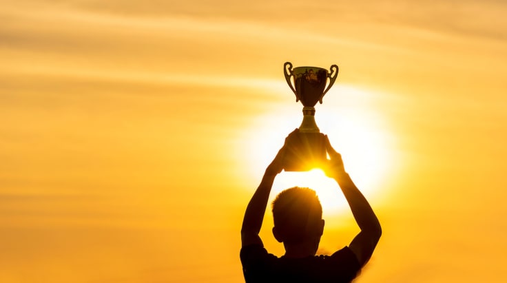 Winner win holding golden champion trophy cup prize. Silhouette best award victory trophy for professional champion challenge team holding gold sport trophy cup over head. Win-Win sport team concept