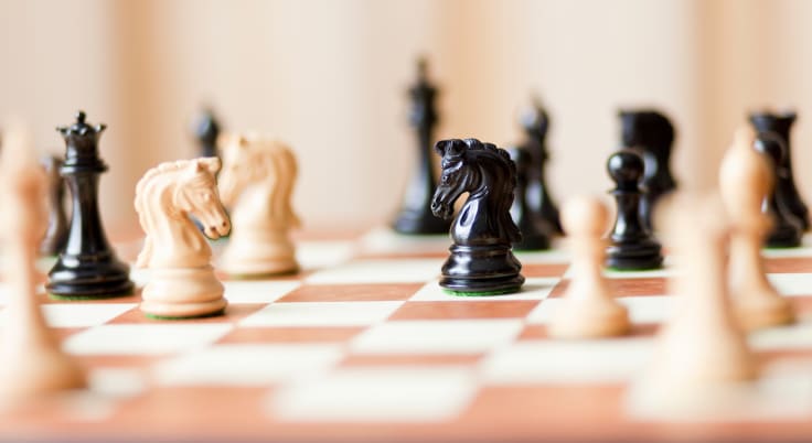 Chess pieces set on a chessboard