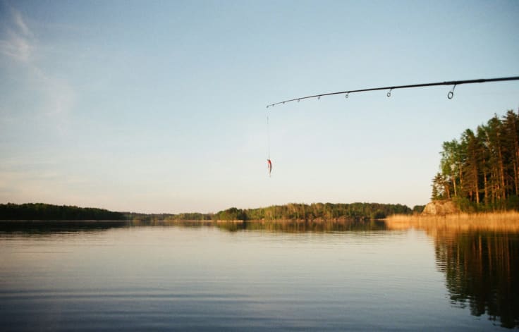 A fishing rod with a bait, an analogy to the interest stage in the buyer's journey.