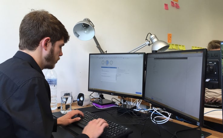 The Chat Shop agent using two monitors to support customers