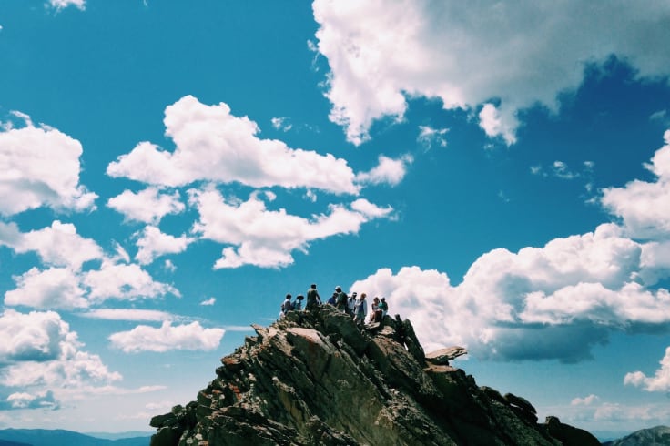 people mountain top corporate team building