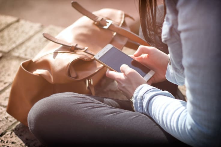 Entrepreneur with a smartphone text messaging sending SMS