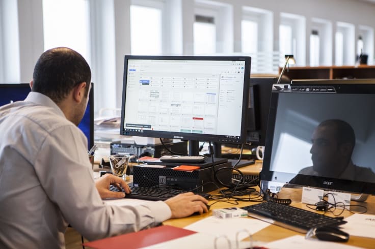 Man using google analytics dashboard in the office on big screen