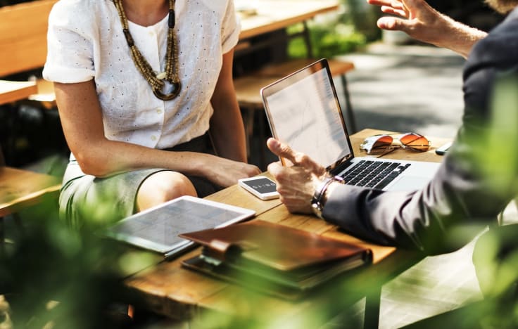 Business outdoor meeting woman and man with laptop