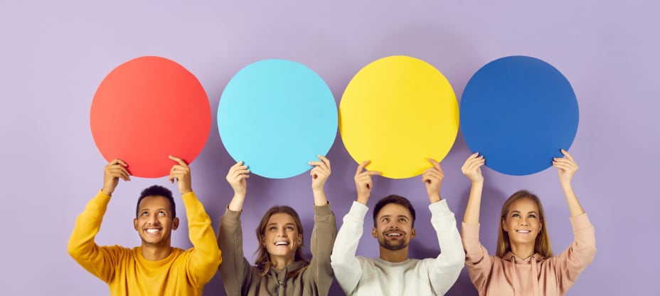 Happy smiling young people holding up colourful speech bubbles