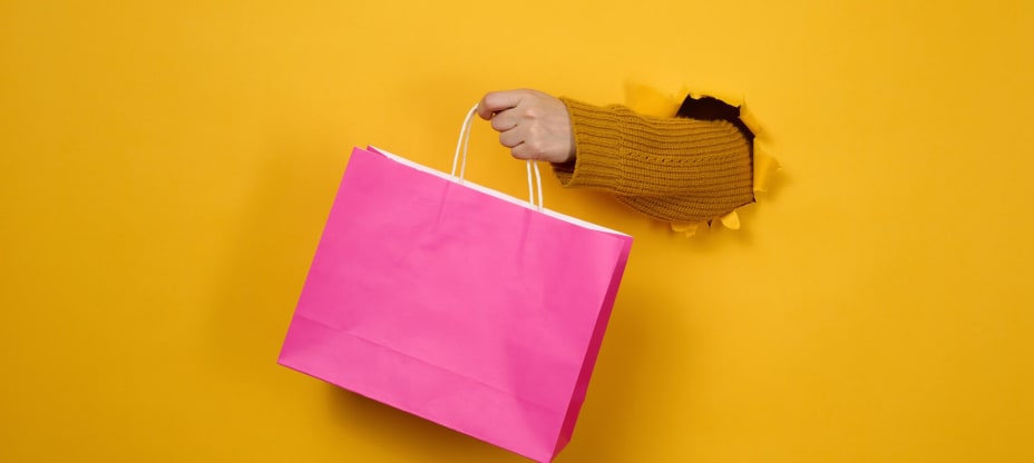 a hand keeping a pink bag