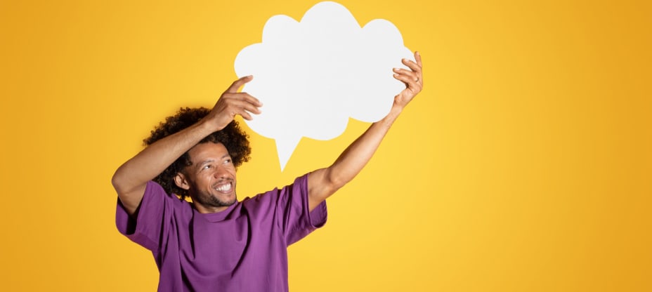 a men in purple t-shirt holding the chat bubble