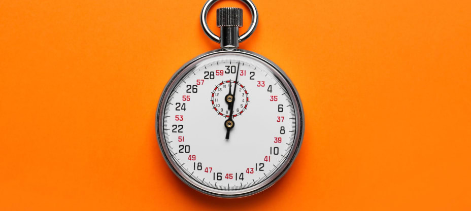 Vintage timer on orange background, top view