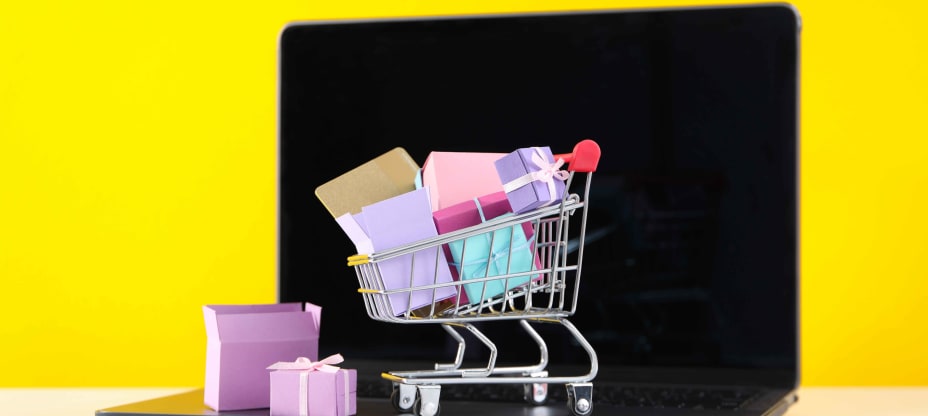 a shopping cart with gifts on a laptop