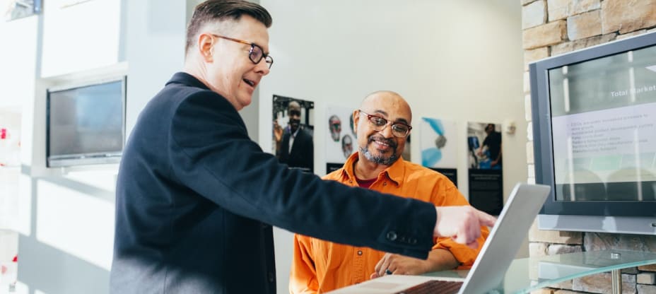 men discussing over a laptop