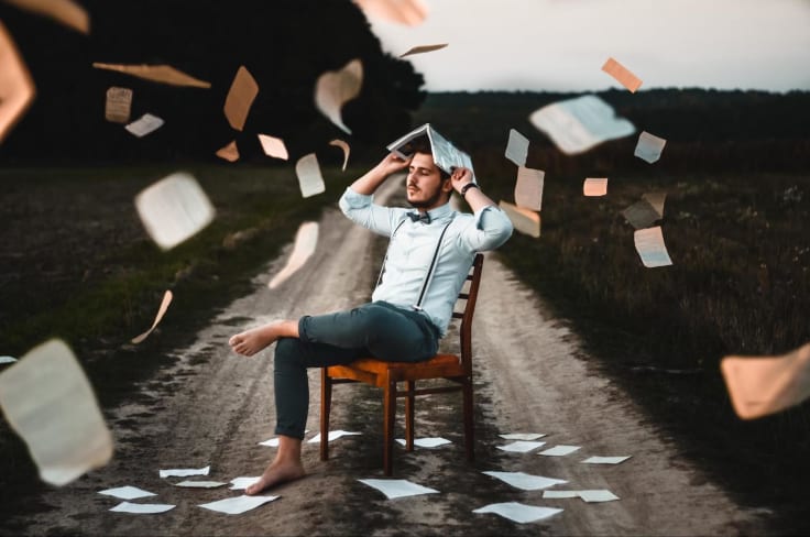 man on chair middle of road