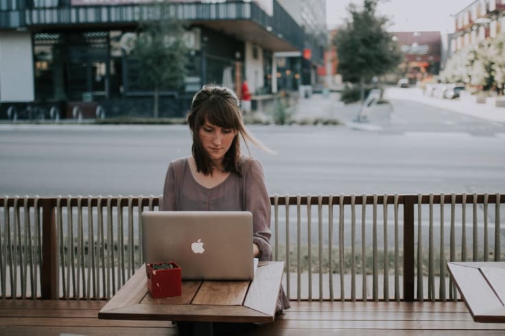 woman with laptop in cafe