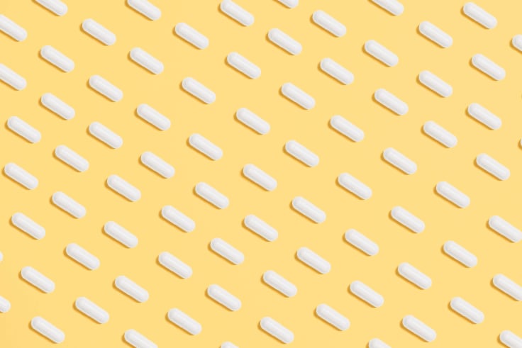 a lot of pills spilled on a yellow background