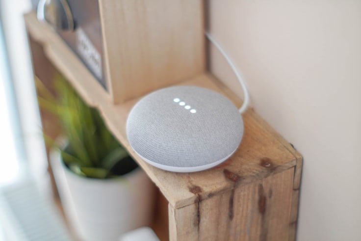 Google Home voice  assistant placed on a shelf