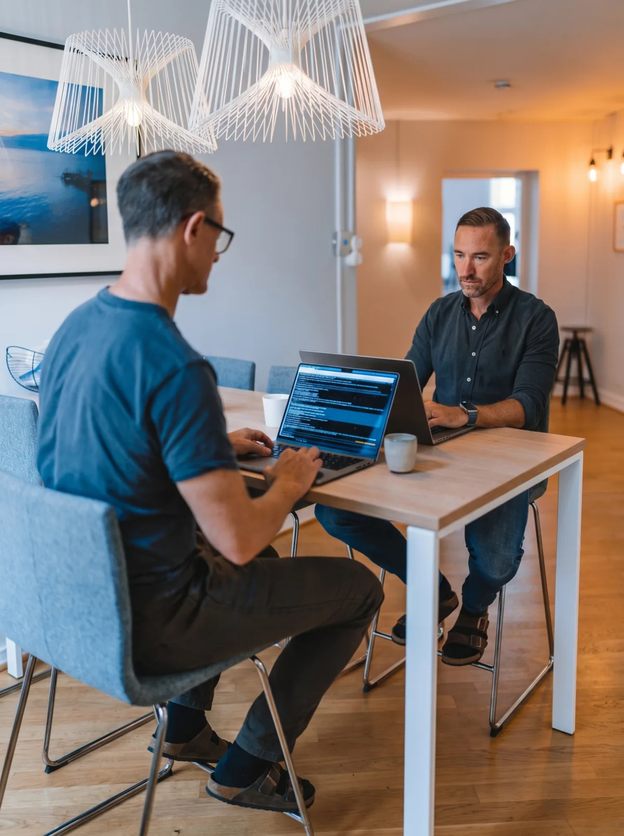 Two Colburn colleagues working together across a laptop